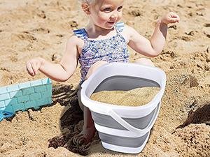 Collapsible bucket used as a beach bucket for family outdoor trips